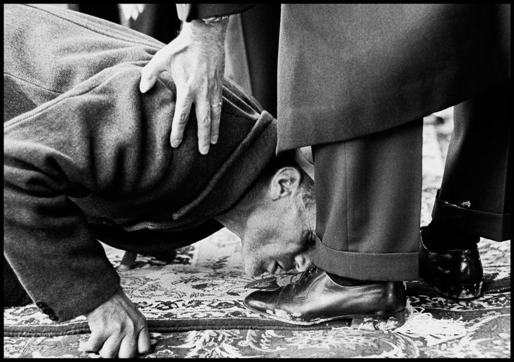 1962_a_peasant_kisses_the_foot_of_mohammad_reza_pahlavi_the_shah_of_iran_as_he_distributes_land_deeds_in_a_ceremony_isfahan_iran.jpeg