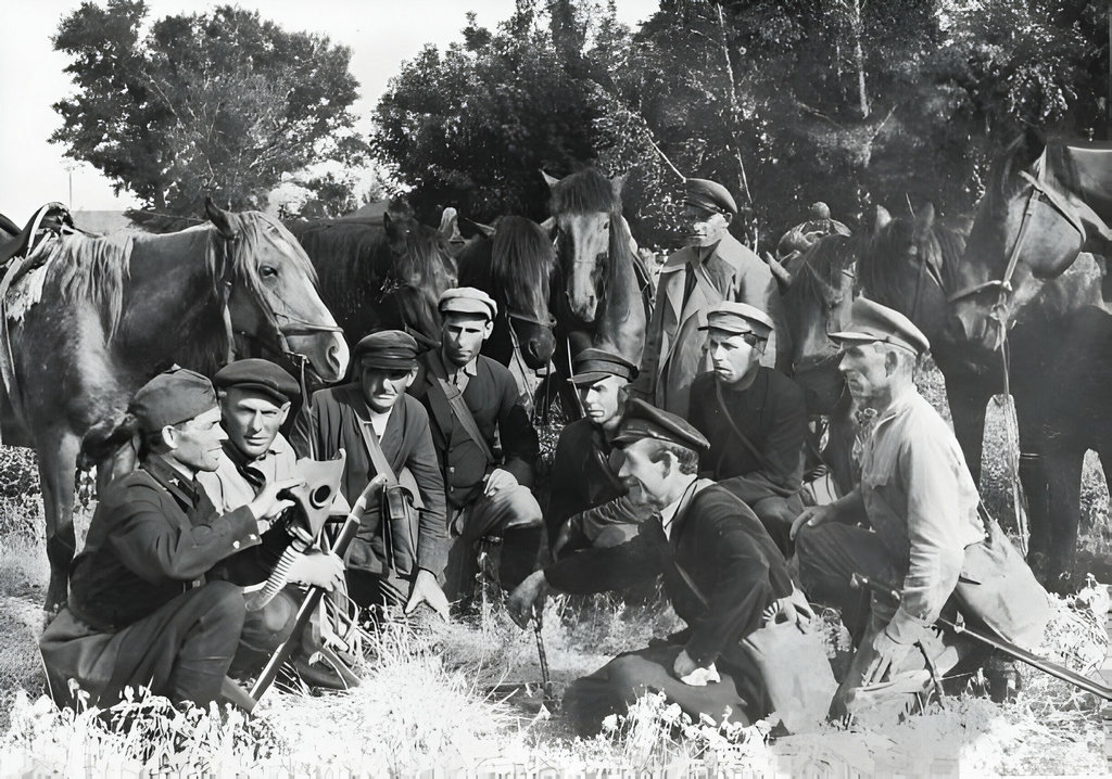 1919_a_group_of_cossack_fighters_crouch_in_a_field_while_a_soldier_demonstrates_the_use_of_a_gas_mask_during_the_russian_civil_war_that_followed_the_bolshevik_revolution.jpg