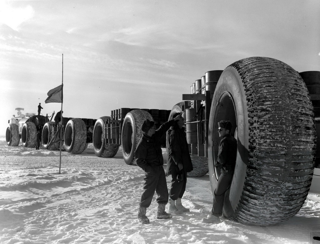 1955_test_and_training_exercise_in_the_arcticthree_soldiers_stand_next_to_a_large_wheel_of_a_vehicle_measuring_9_feet_in_diameter_antarctica_cr.jpg