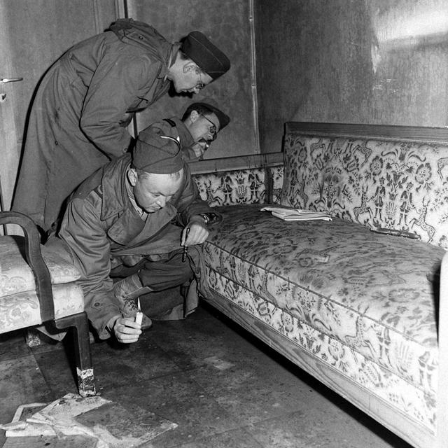 1945_allied_war_correspondents_examining_the_couch_in_adolf_hitler_s_bunker_on_which_he_is_thought_to_have_shot_himself_with_his_wife_eva_braun.jpeg