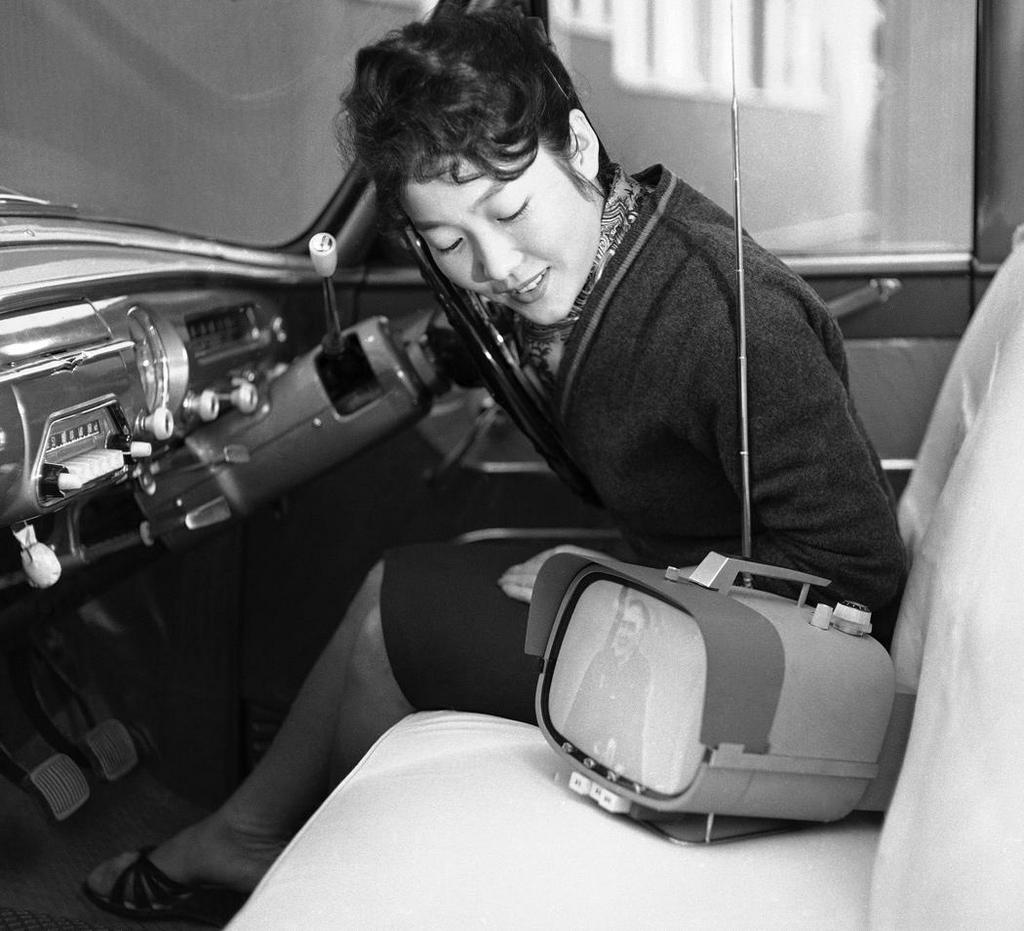 1960_a_woman_watching_the_sony_tv8-301_a_portable_tv_japan.jpeg