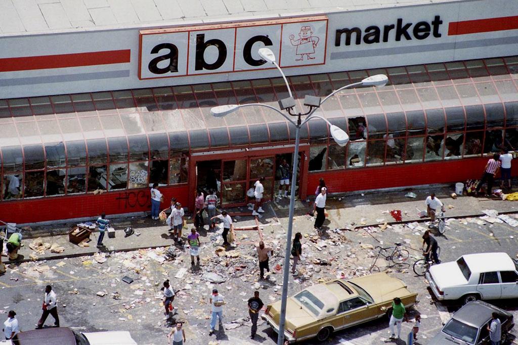 1992_looters_mill_in_the_parking_lot_of_the_abc_market_in_south_central_los_angeles.jpeg