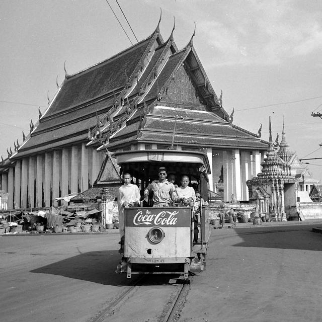 1950_monks_riding_a_tram_outside_wat_pho_temple_bangkok_thailand.jpeg