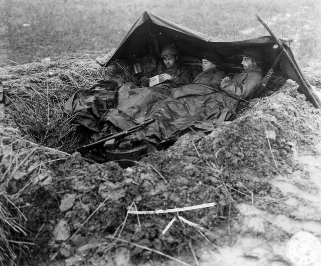 1944_3_american_soldiers_eat_thanksgiving_menu_in_dugout_near_fauquermont_france.jpeg
