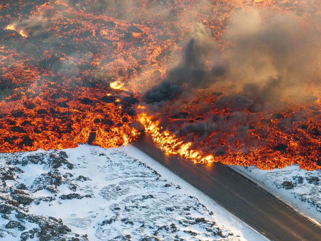 2024_02_08_lava_crosses_the_main_road_to_grindavik_and_flows_on_the_road_leading_to_the_blue_lagoon_in_grindavik_iceland_marco_di_marcoap.jpg