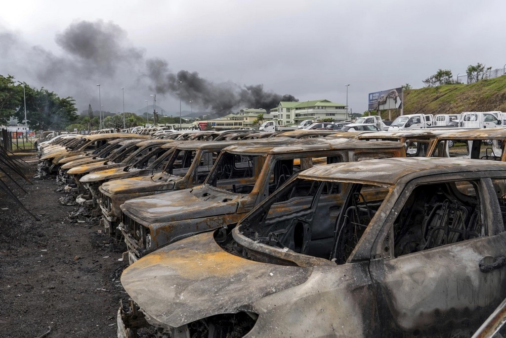 2024_05_15_burnt_cars_are_lined_up_after_unrest_that_erupted_after_protests_over_voting_reforms_in_noumea_in_new_caledonia_ap_photo_nicolas_job.jpg