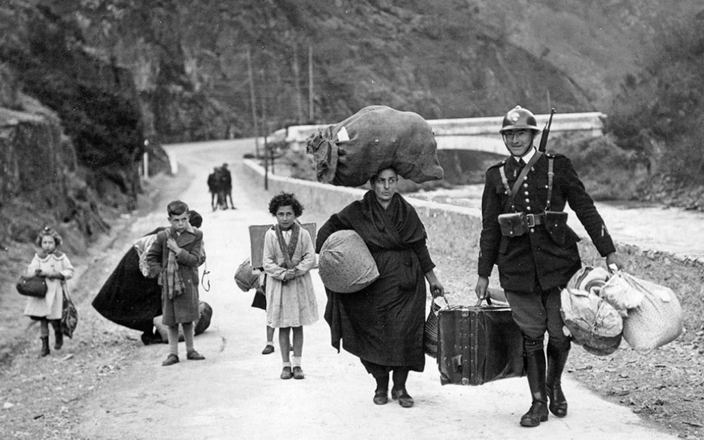 1938_french_border_guard_helping_spanish_family_to_cross_the_french_border_during_spanish_civil_war.png