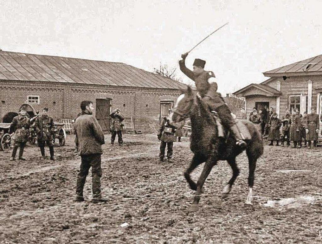 1941_cossack_policeman_to_the_amusement_of_hungarian_soldiers_slashes_a_captured_soviet_partisan_with_a_saber_occupied_ukraine.jpeg