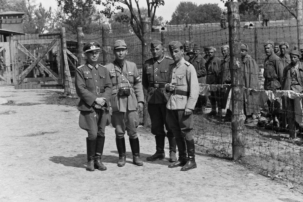 1942_japanese_photojournalist_sunji_sasamoto_attached_to_the_2nd_hungarian_army_poses_with_german_and_hungarian_soldiers_in_a_soviet_pow_camp_in_occupied_kursk_region.jpeg