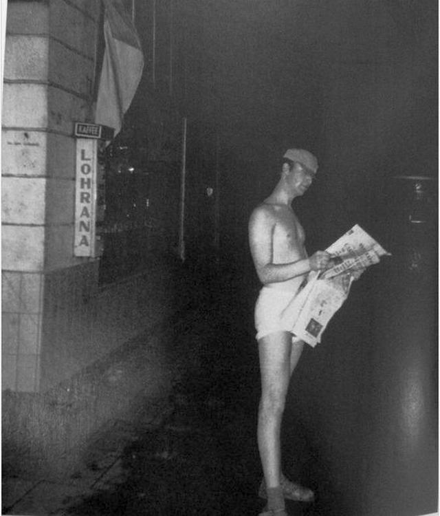 1960_john_lennon_standing_in_his_underwear_and_reading_the_newspaper_on_the_street_hamburg.jpeg