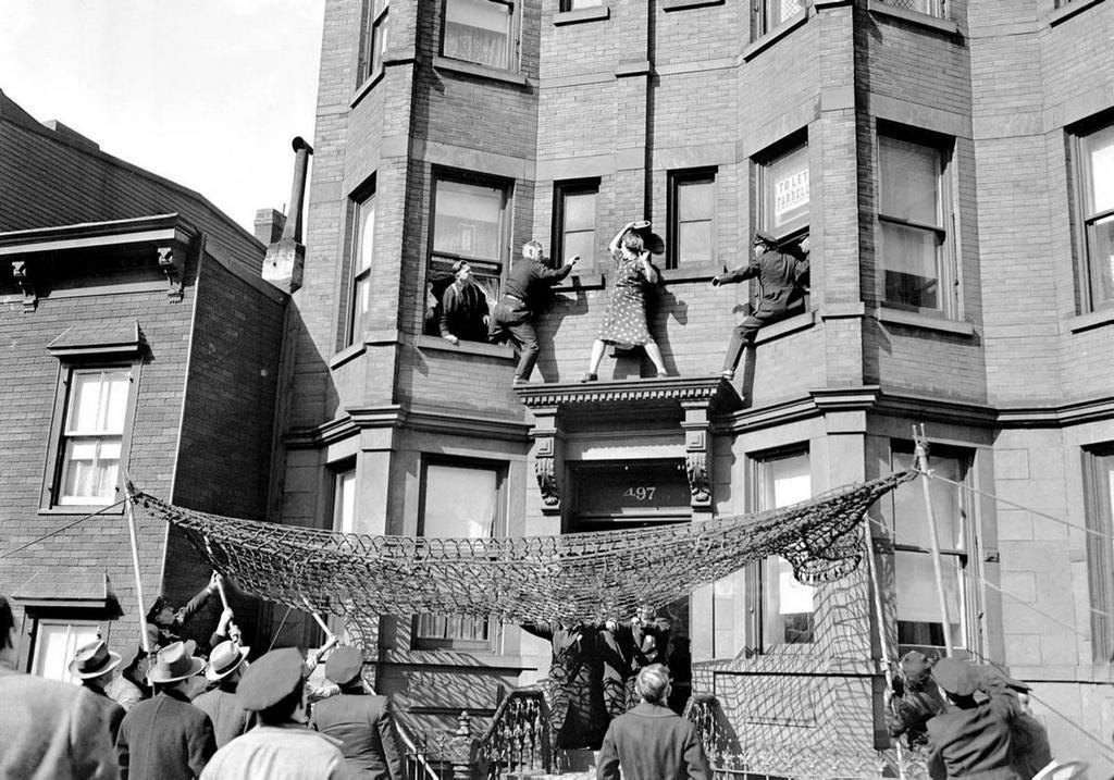 1942_edna_egbert_fights_with_the_police_as_they_try_to_prevent_her_from_jumping_off_the_second-story_ledge_of_her_home_at_497_dean_street_in_brooklyn2.jpeg