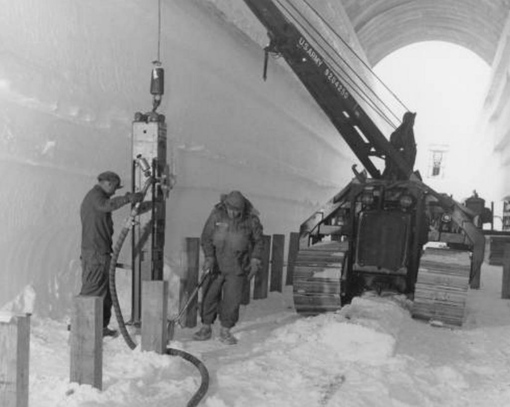 1959_us_army_polar_research_and_development_center_using_a_pile-driver_to_lay_the_foundations_of_a_water_storage_building_at_camp_century_an_arctic_united_states_military_scientific_research_base_in_greenland.jpg