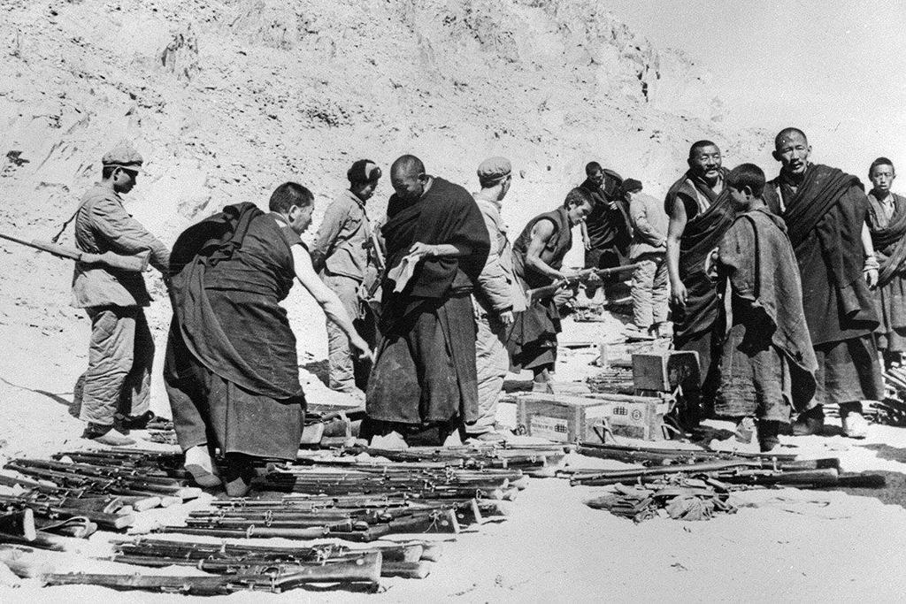 1959_tibetan_monks_surrender_their_weapons_to_chinese_soldiers_after_a_failed_uprising.jpeg