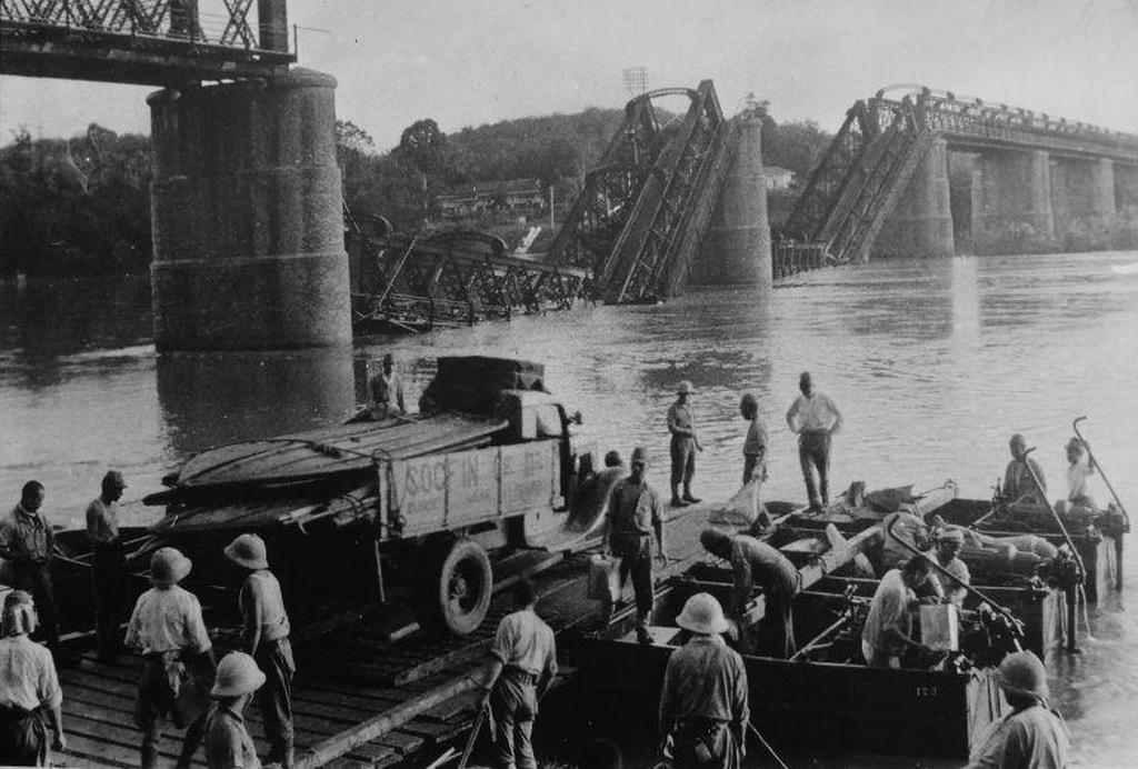 1942_japanese_soldiers_on_a_ferry_with_a_truck_near_the_bridge_over_the_perak_river_in_malaya_which_was_blown_up_by_british_troops.jpeg