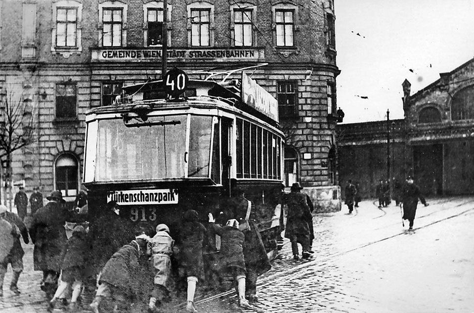1934. Az osztrák polgárháborúban az éppen kikapcsolt áramszolgáltatás idején az utasok tolják a bécsi villamost..jpg