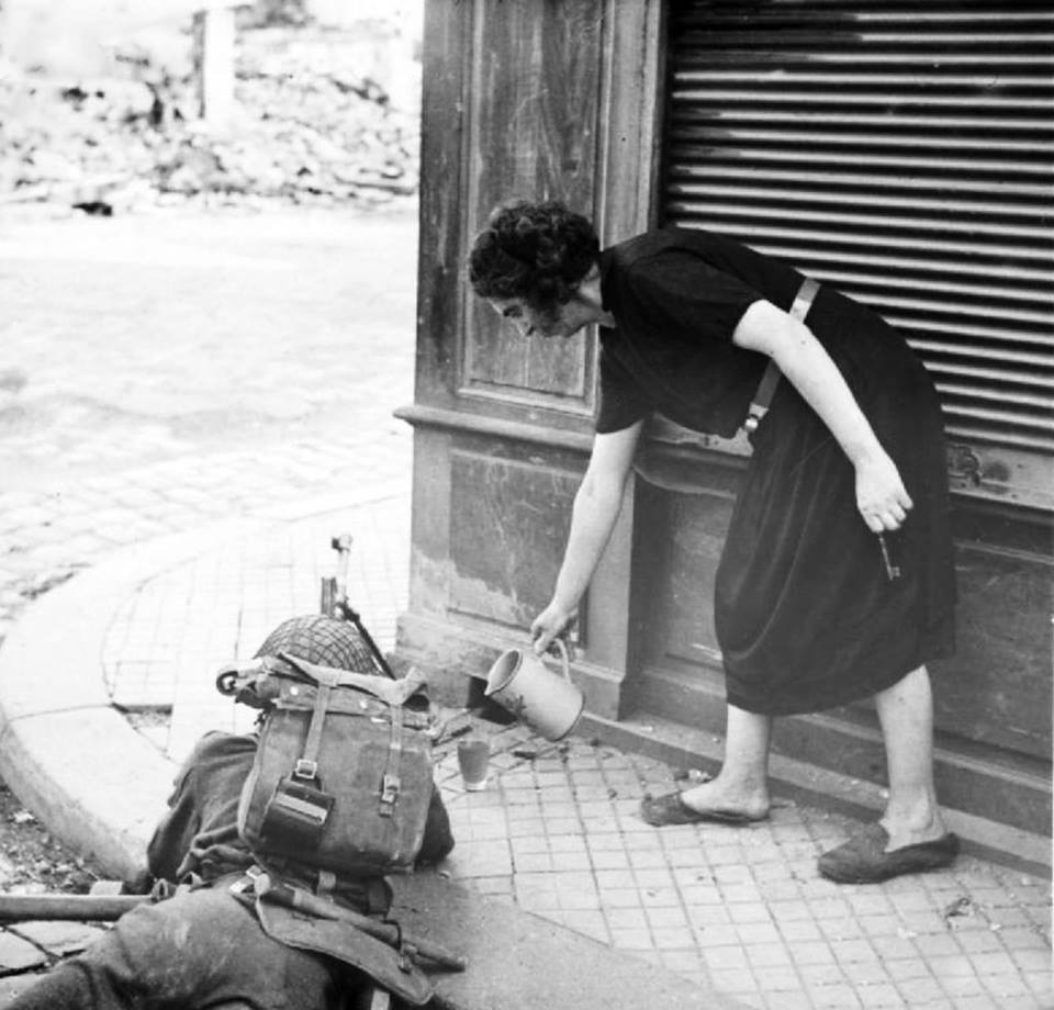 a_war-weary_french_woman_pours_a_british_soldier_a_cup_of_tea_during_the_fighting_following_the_allied_landings_in_normandy_lisieux_calvados_lower_normandy_france_22_august_1944.jpg