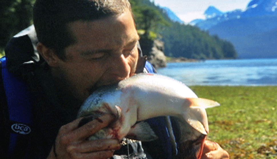 bear-grylls-bites-into-an-alaskan-salmon-straight-out-of-the-river.jpg