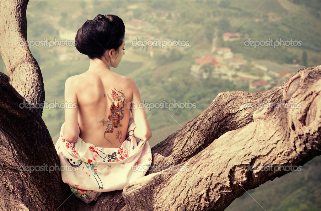 depositphotos_15870717-woman-with-snake-tattoo-on-her-back-on-the-tree-branch.jpg