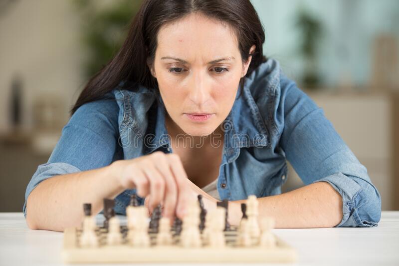 beautiful-brunette-woman-playing-chess-beautiful-brunette-woman-playing-chess-woman-198491920.jpg