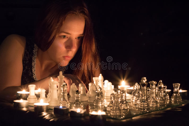 candlelight-chess-portrait-woman-playing-64334136.jpg