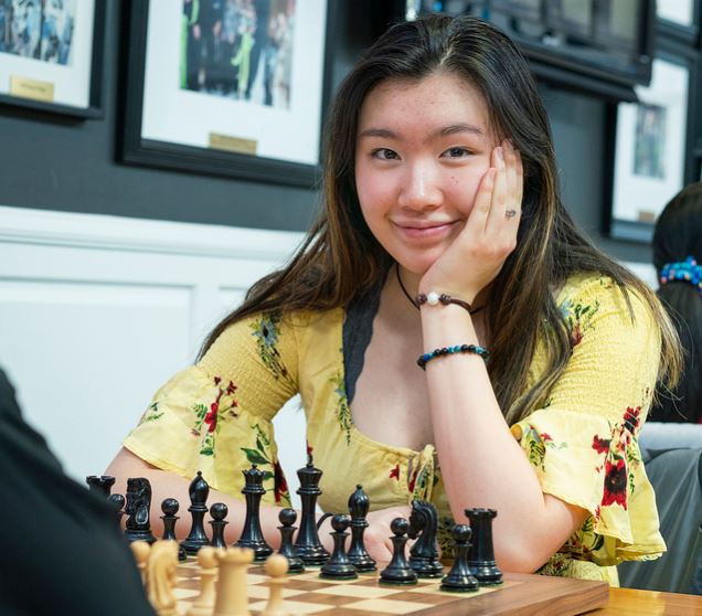 jennifer-yu-sitting-at-chessboard-smiling-17-years-old-20190327.jpg