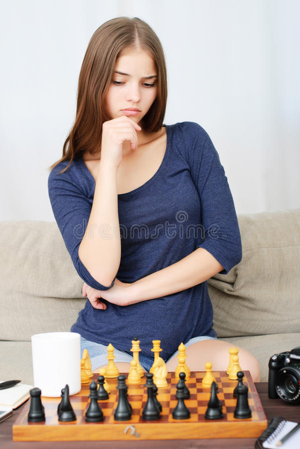 beautiful-brunette-young-woman-playing-chess-portrait-78538255.jpg