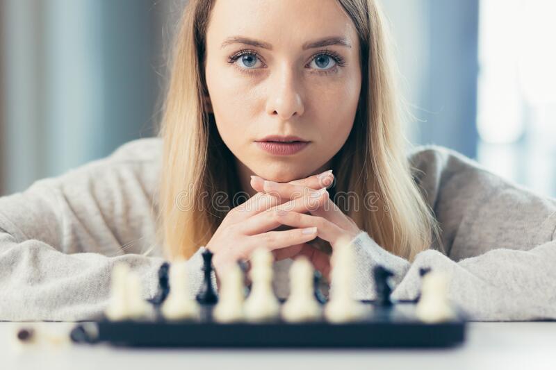 close-up-photo-blonde-woman-playing-chess-thoughtfully-making-move-beautiful-220031483.jpg