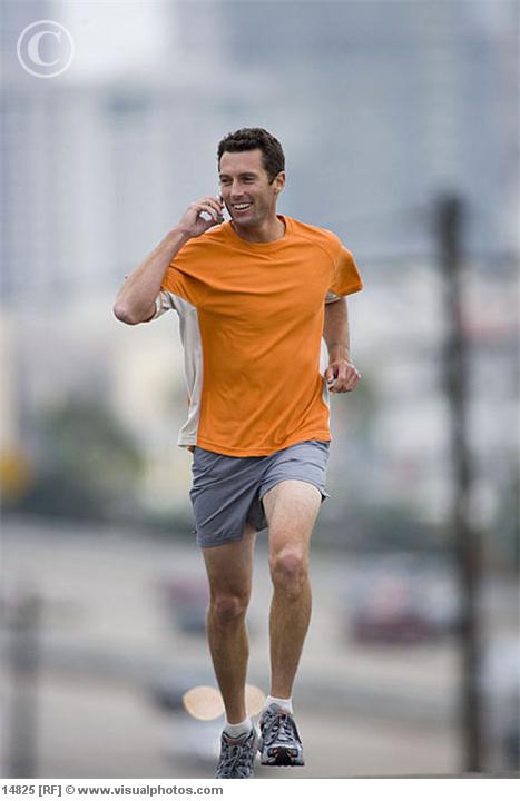 man_running_outdoors_using_mobile_phone_14825.jpg