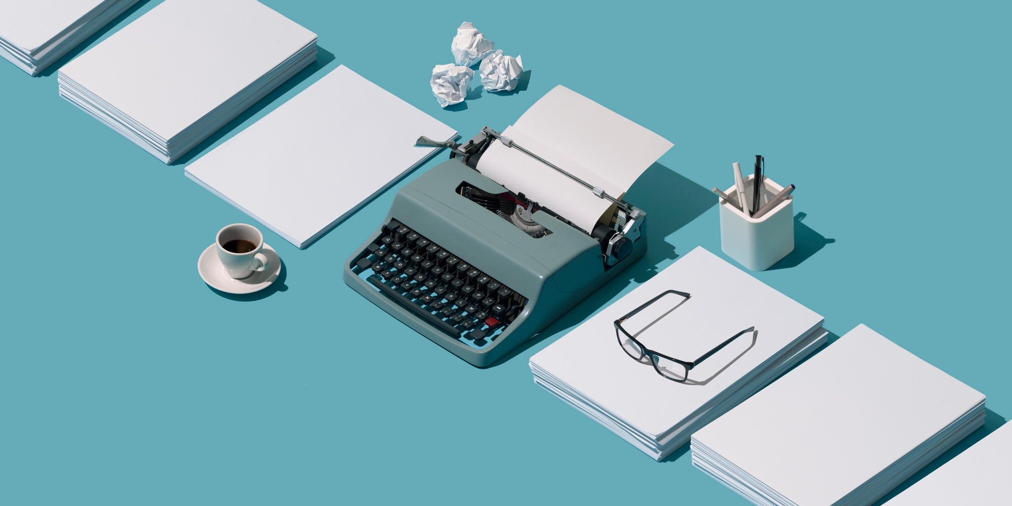 vintage-typewriter-header-and-blank-sheets-mybrtxa.jpg
