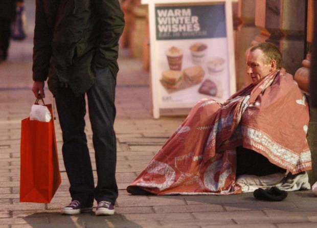 homeless-man-sits-outside-entrance-green-park-tube-station-christmas-eve-central-london.jpg