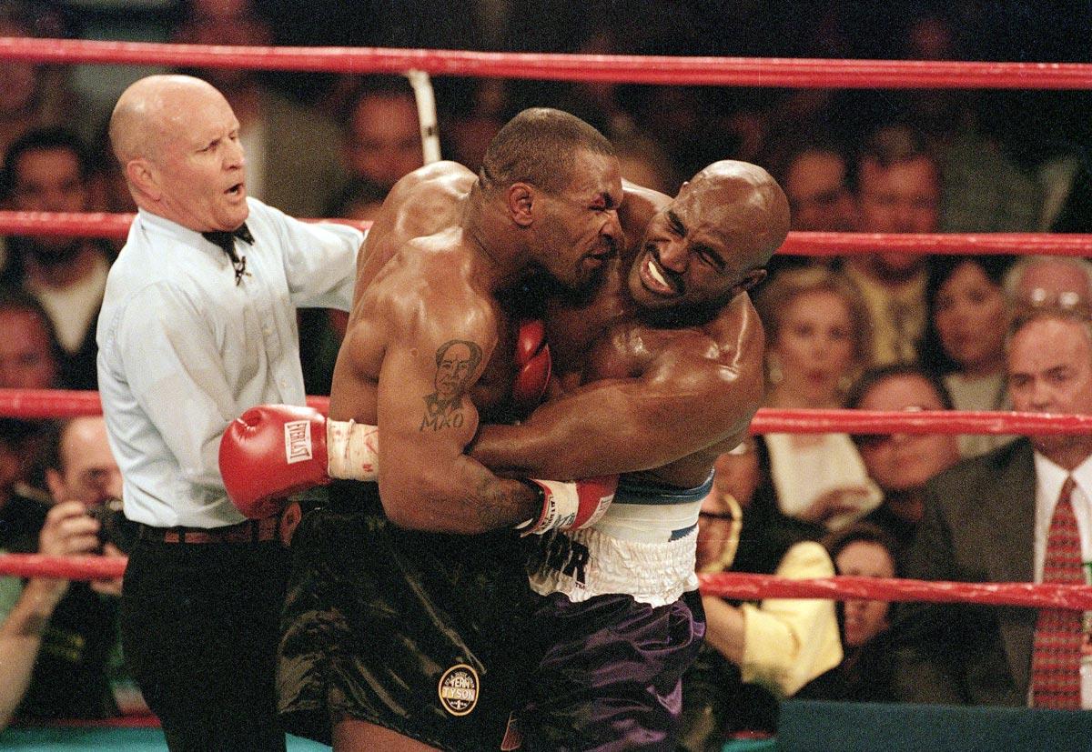 june_28_1997_mike_tyson_bites_the_ear_of_evander_holyfield_during_their_1997_heavyweight_fight_tyson_s_boxing_license_was_temporarily_revoked_for_the_incident_and_he_was_fined_3_million.jpg