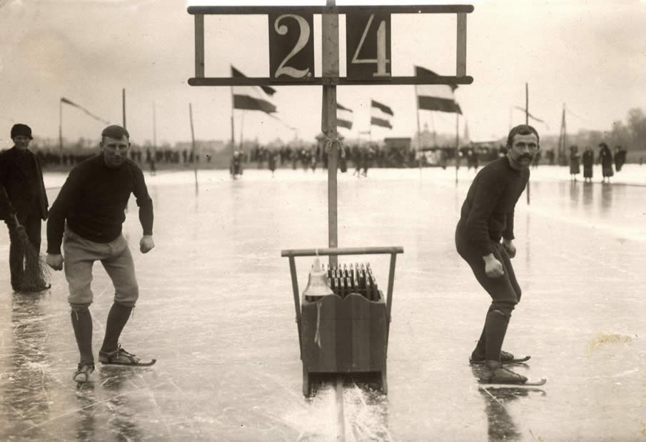 speed_skating_dutch_skaters_lijkle_poepjes_and_b_van_der_zee_standing_ready_for_the_start_of_a_skating_race_in_leeuwarden_the_netherlands_1914.jpg