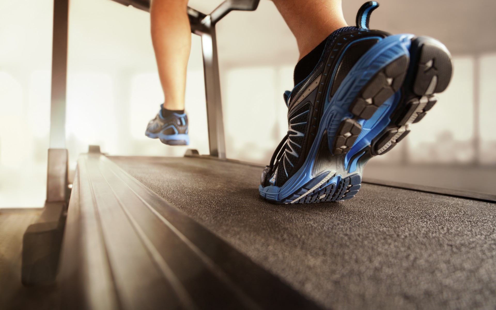 man-wearing-blue-shoes-running-on-treadmill-in-a-gym-room-fitness.jpg