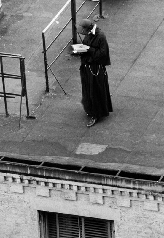 André Kertész - Nun standing on Roof, Reading, 1962..jpg