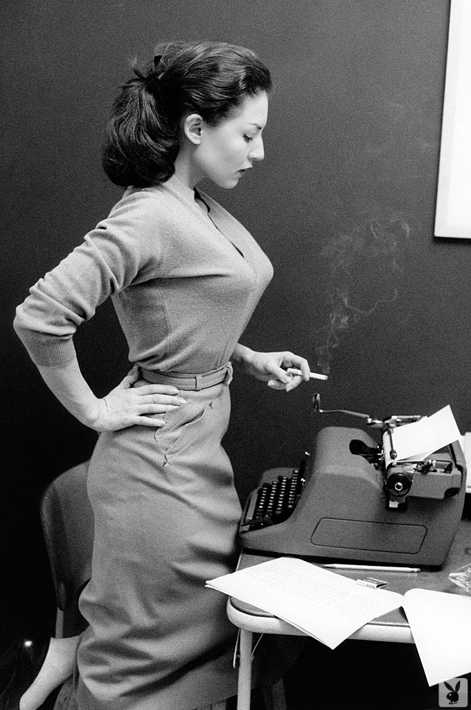 Opera singer Maria Callas writing and reading at a Royal Typewriter.  Smoking..jpg