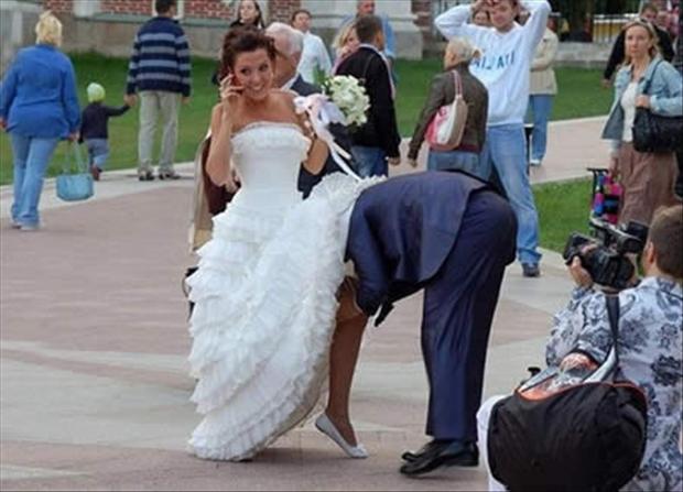 funny-wedding-pictures-groom-taking-off-brides-garder.jpg
