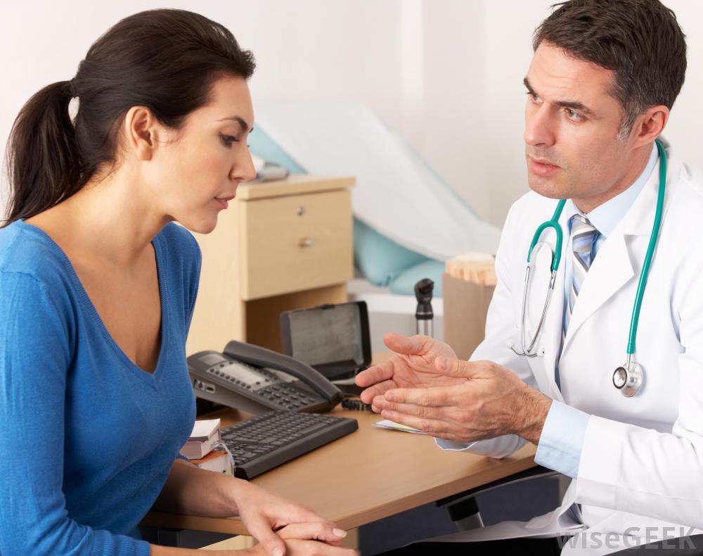 woman-in-blue-shirt-speaking-with-male-doctor-in-a-lab-coat.jpg