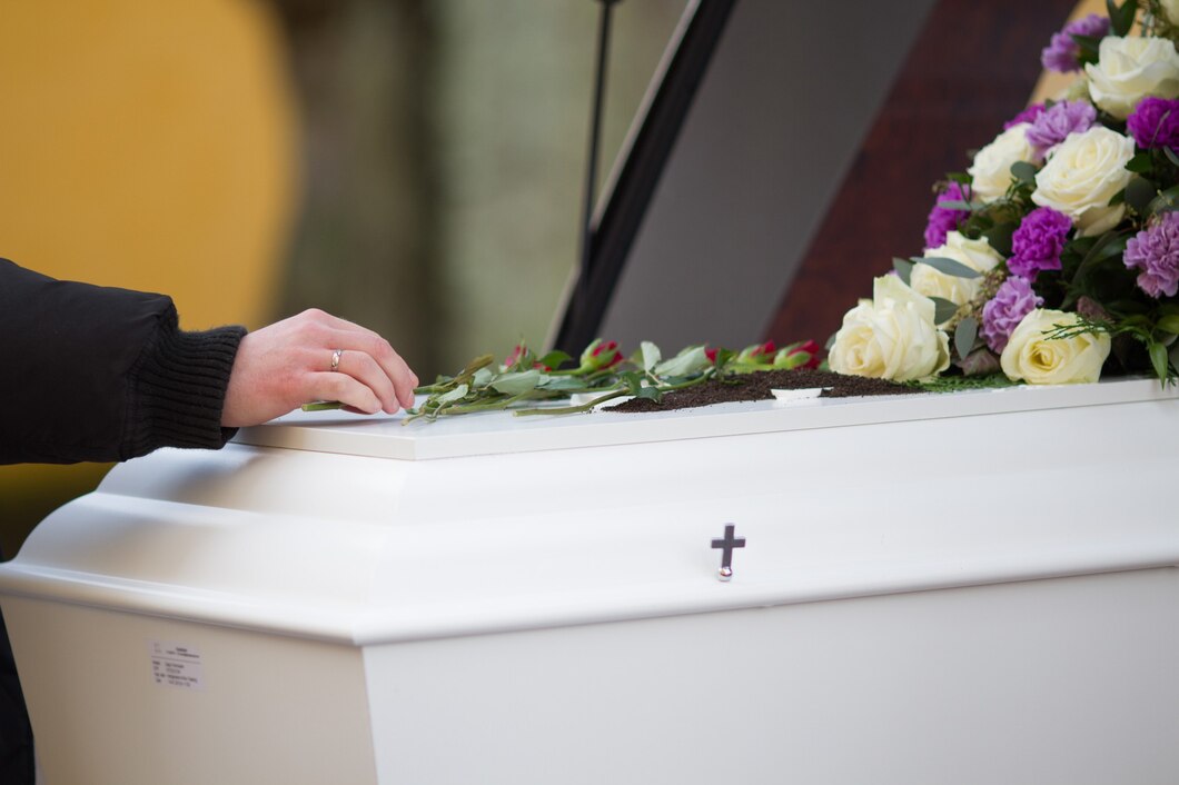 closeup-shot-person-hand-casket-with-blurred-background_181624-13563.jpg