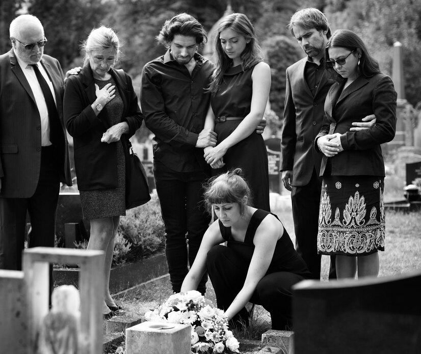 family-laying-flowers-grave_53876-139561.jpg