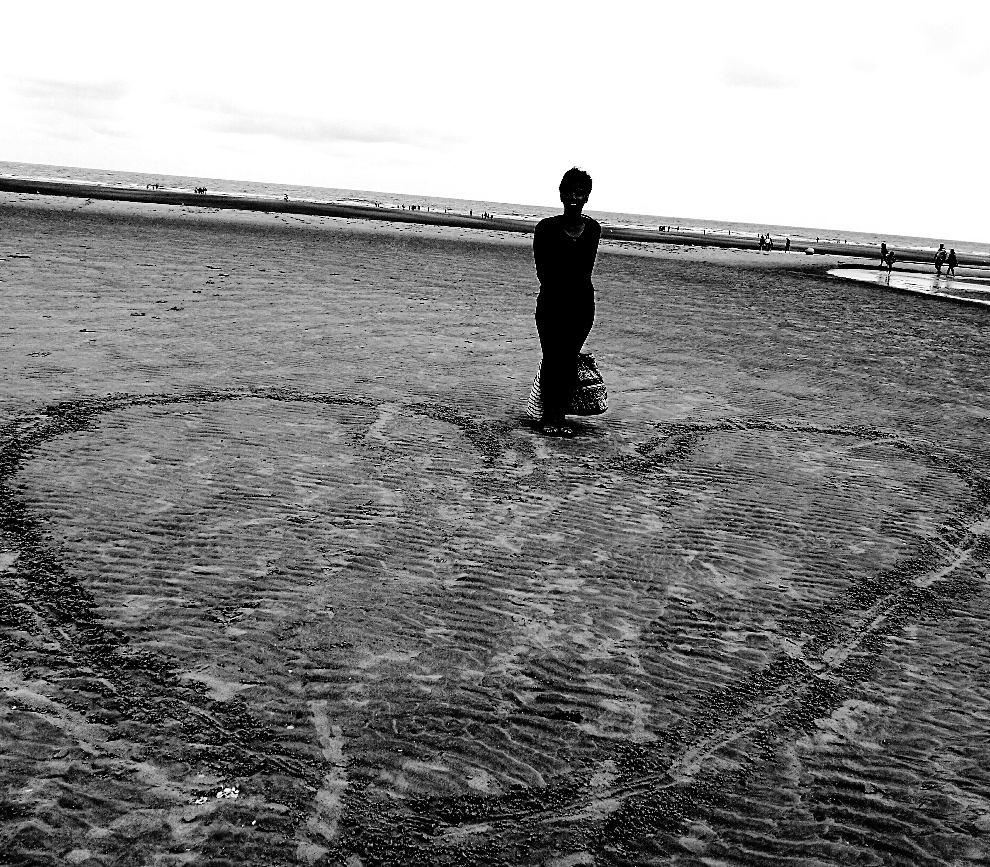 full-length-woman-standing-heart-shape-drawn-beach-against-clear-sky.jpg