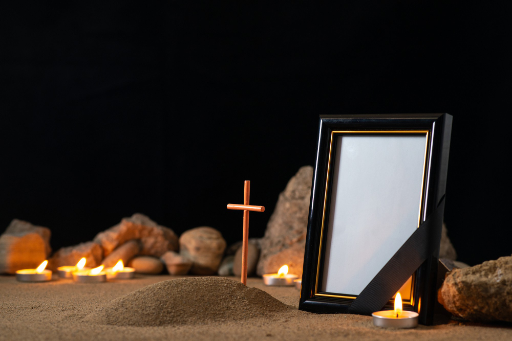 picture-frame-with-stones-candles-little-grave-dark-surface.jpg