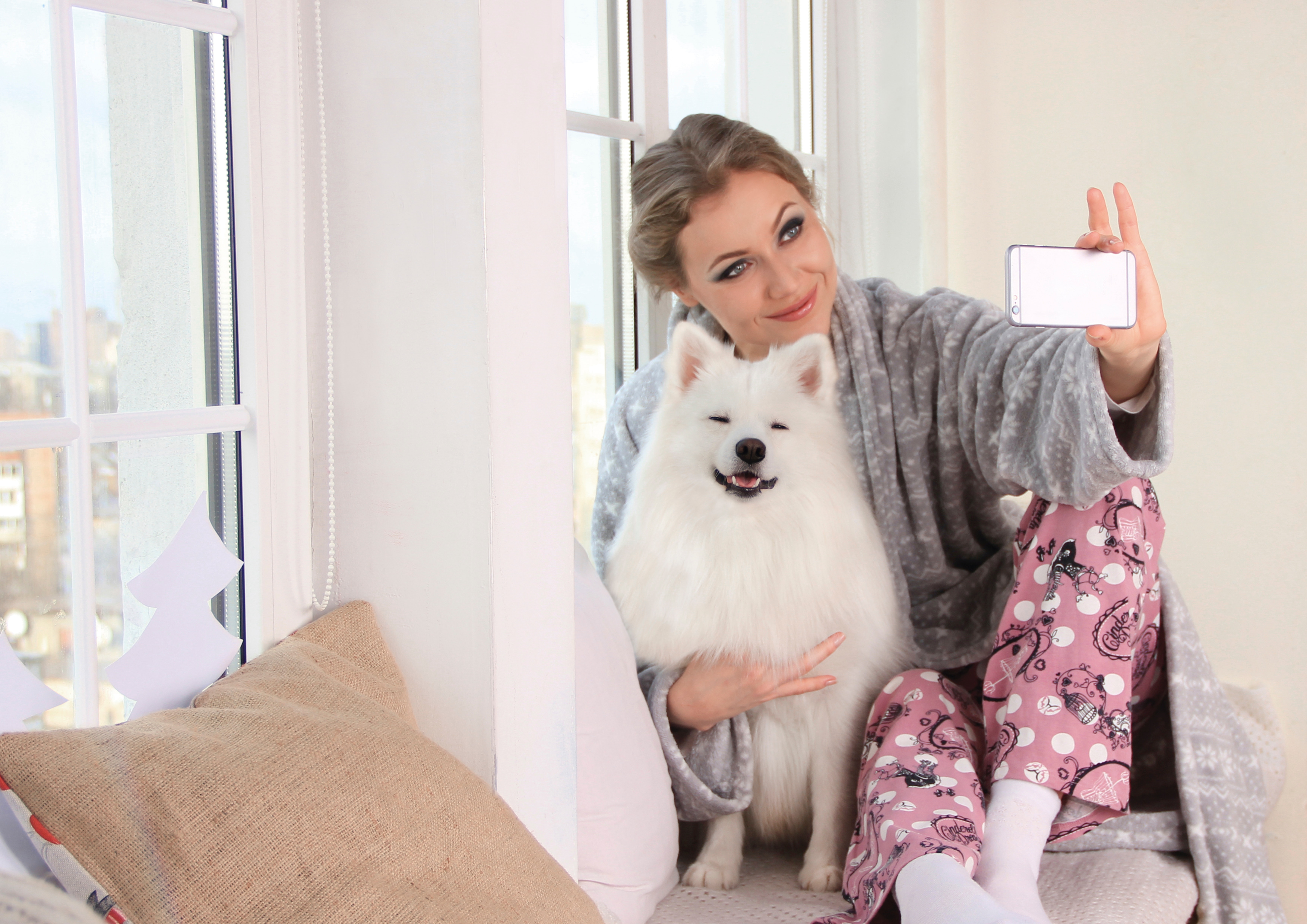 woman-taking-a-photo-of-herself-with-white-dog-1198869.jpg