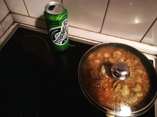 Pork shoulder steamed in beer with turmeric is getting ready