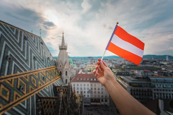 depositphotos_344052448-stock-photo-woman-holds-austria-flag-in.jpg