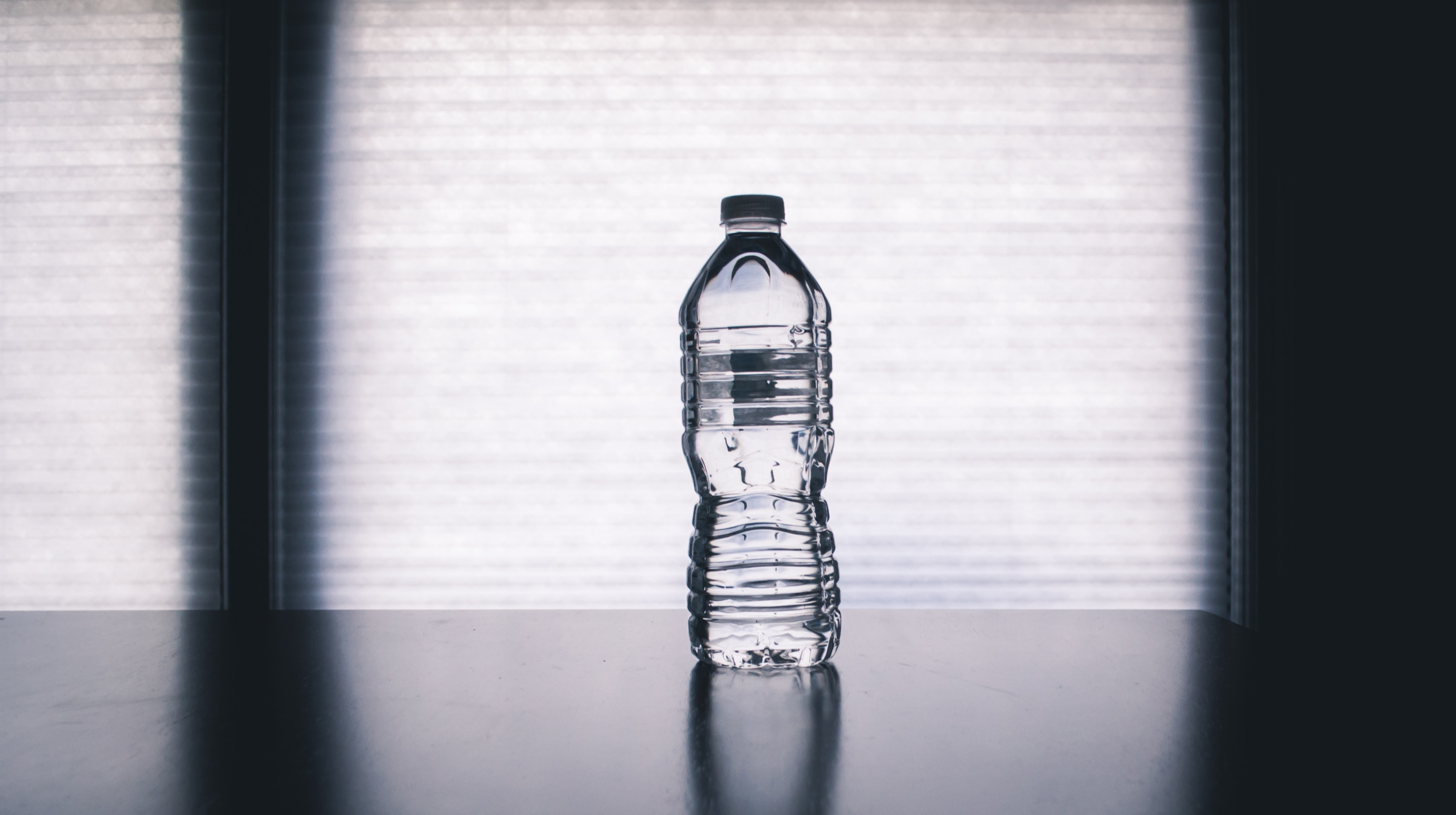 clear-disposable-bottle-on-black-surface-1000084.jpg
