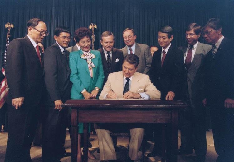 ronald_reagan_signing_japanese_reparations_bill_jpg_800x600_q85_crop.jpg