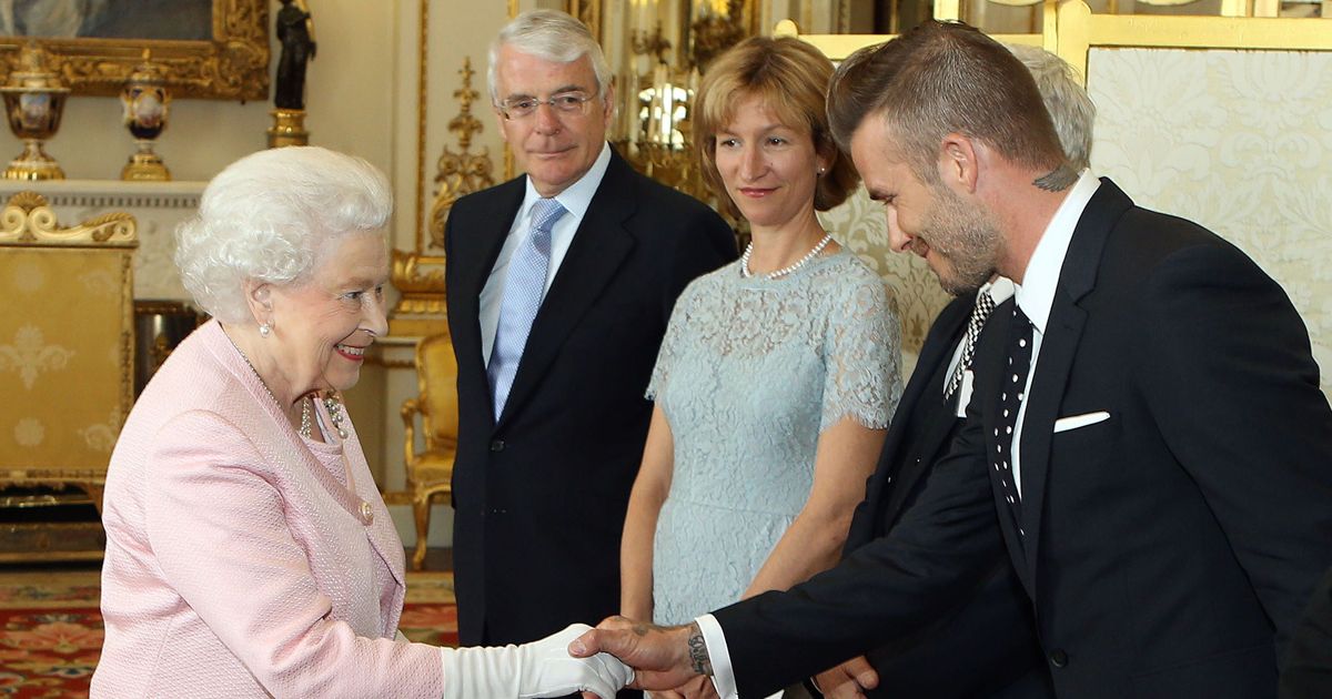 britains-queen-elizabeth-ii-l-shakes-hands-with-former-england-footballer-david-beckham.jpg