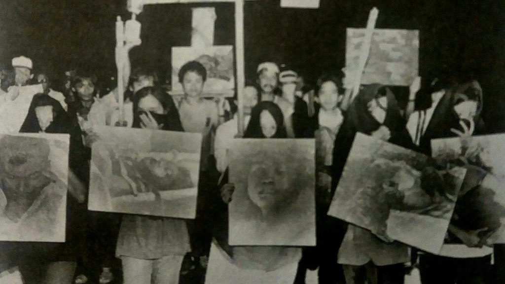 1986_rally_against_the_marcos_dictatorship_in_which_protesters_hold_up_images_of_escalante_massacre_victims.jpg