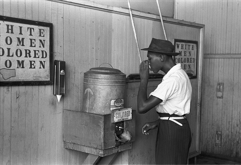 _colored_drinking_fountain_from_mid-20th_century_with_african-american_drinking.jpg