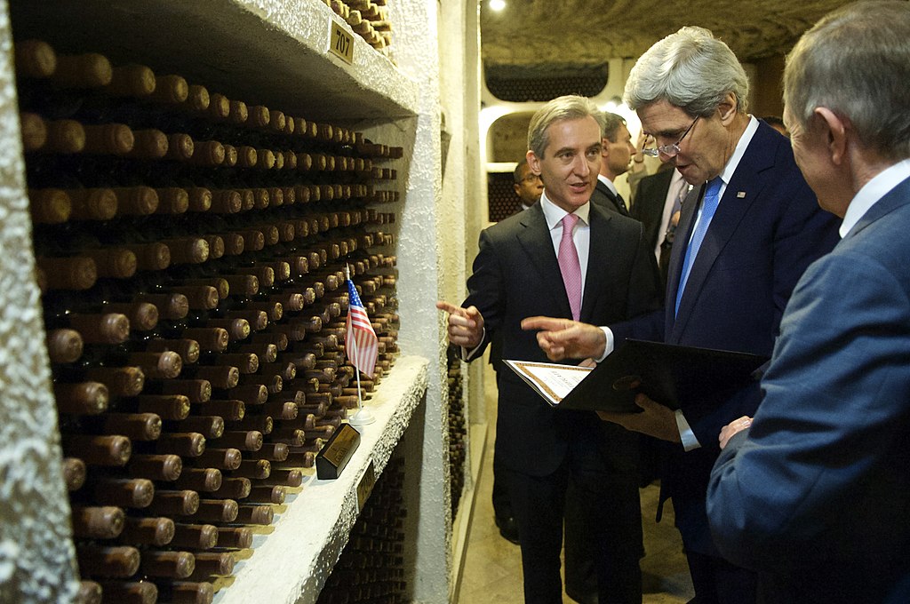 secretary_kerry_examines_a_certificate_as_the_moldovans_designate_a_bin_of_wine_in_his_honor_11211930044.jpg